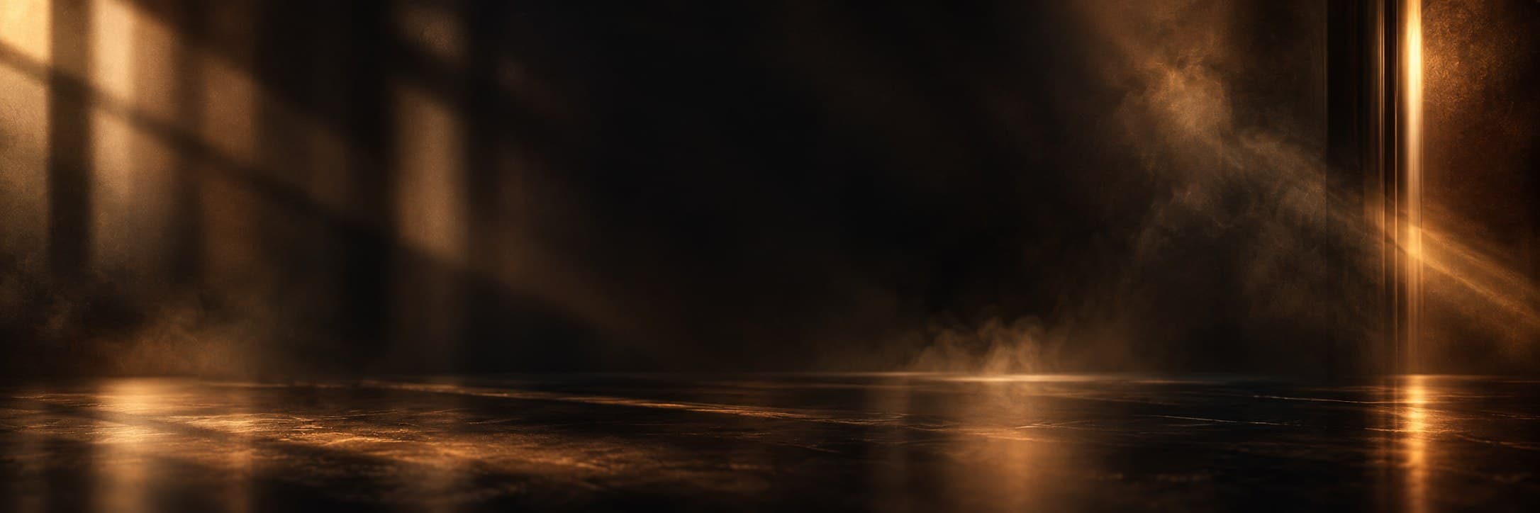 An empty, softly lit room with gold light streaming through and drifting haze